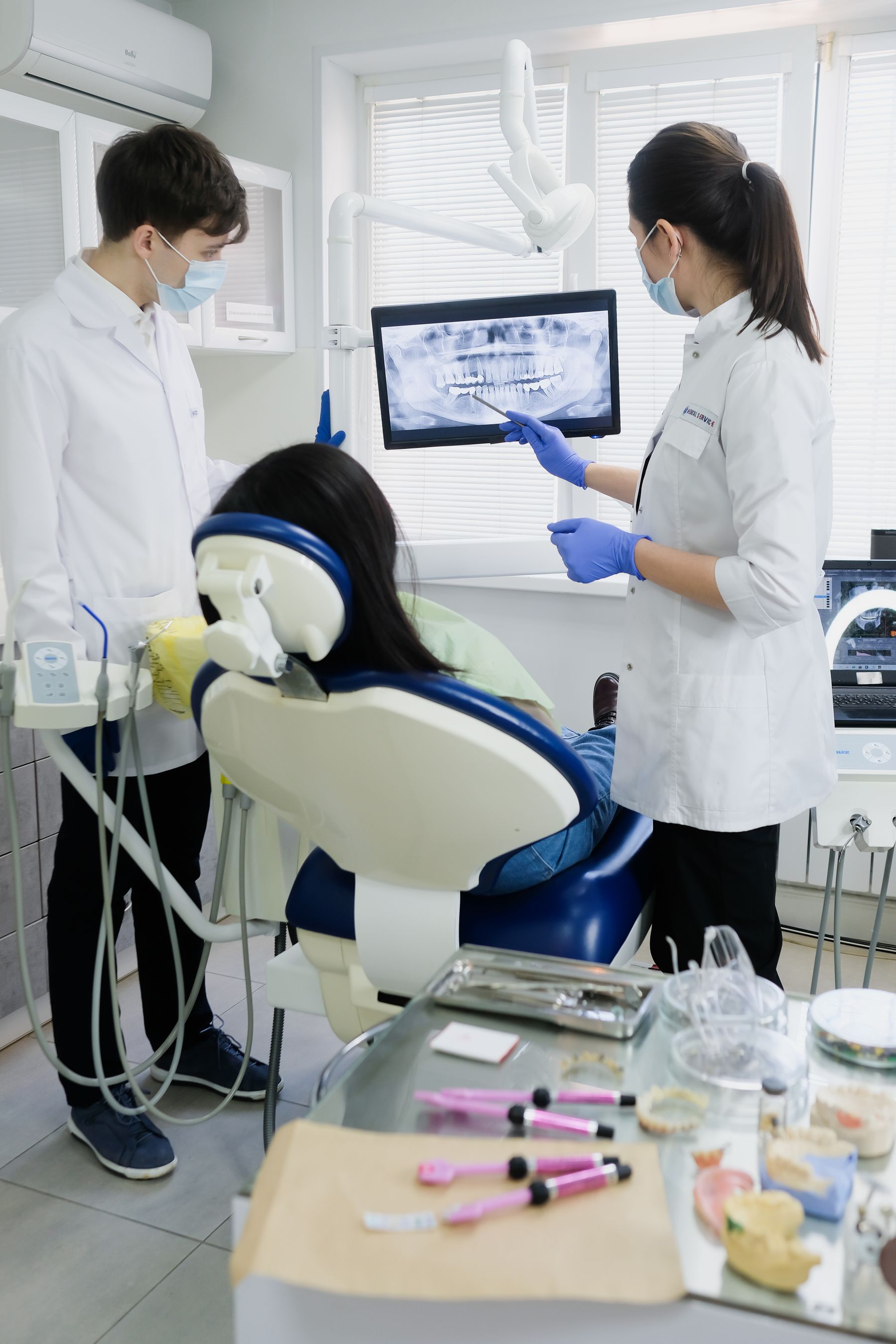 Two dentists reviewing a dental x ray on a screen